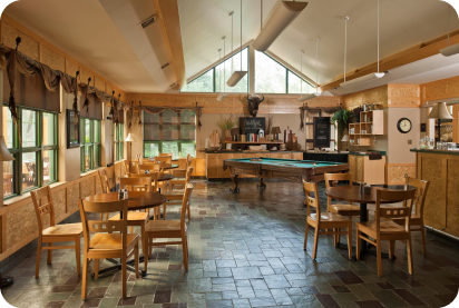 Dining area at Elk Lake Lodge. Lovely wood room with dining tables and pool table